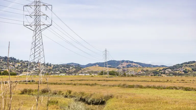 Electricity transmission lines crossing open countryside